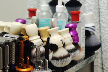 A collection of shaving brushes, razors, and grooming products.